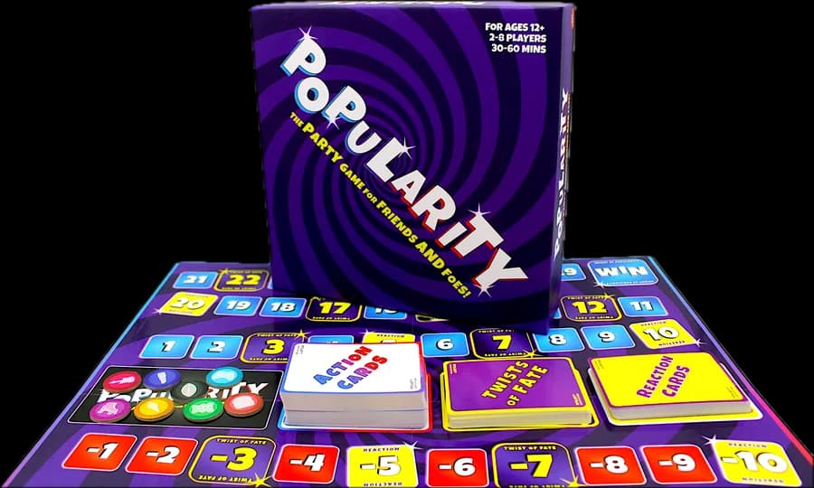 The Popularity box standing on its board, with the Action, Twist of Fate and Reaction decks and the player tokens
